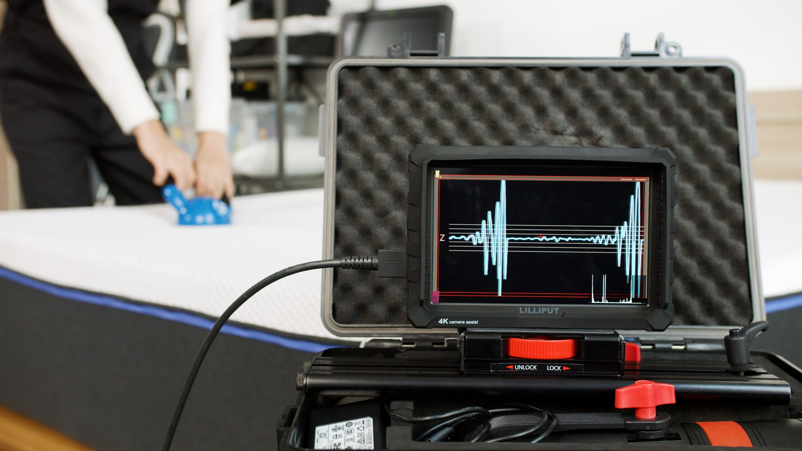 Tester using a motion detector to test the Nectar Premier for motion isolation