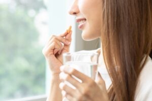 woman taking glycine supplement