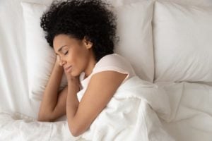 woman with curly hair laying on her arms