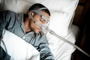 Man sleeping with CPAP machine