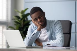 Man nodding off at desk