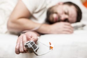 Man sleeping and getting oxygen levels measured