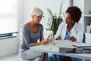 a person speaks with their doctor